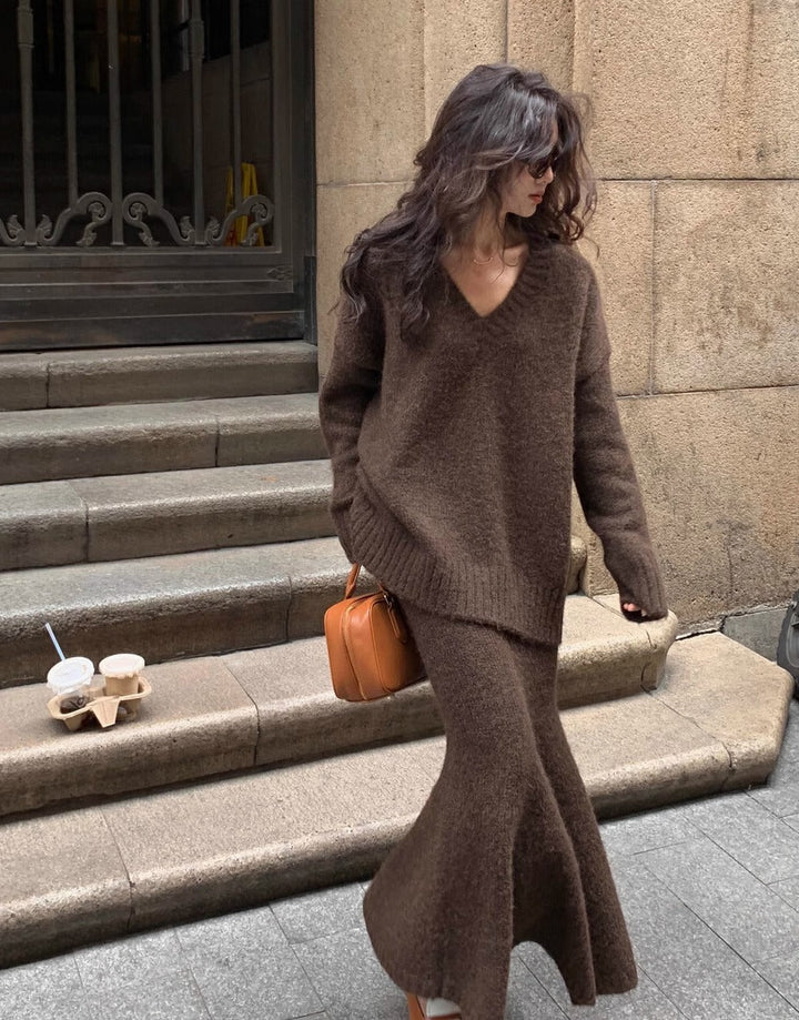 Elegant women's V-neck long sleeve sweater and midi skirt matching set. Chic two-piece knit outfit for versatile style.