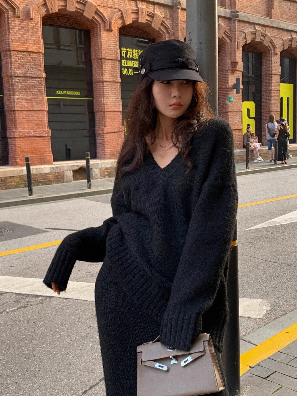 Women's elegant V-neck long sleeve sweater with matching midi skirt set. Stylish two-piece knit outfit for women.