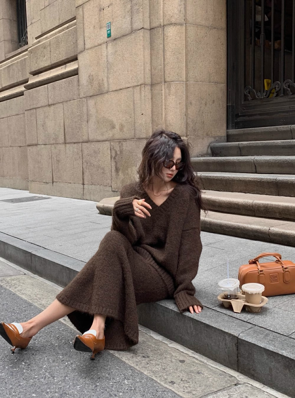Women's V-neck long sleeve sweater top & midi skirt matching set. Elegant two-piece knit outfit for chic fashion.