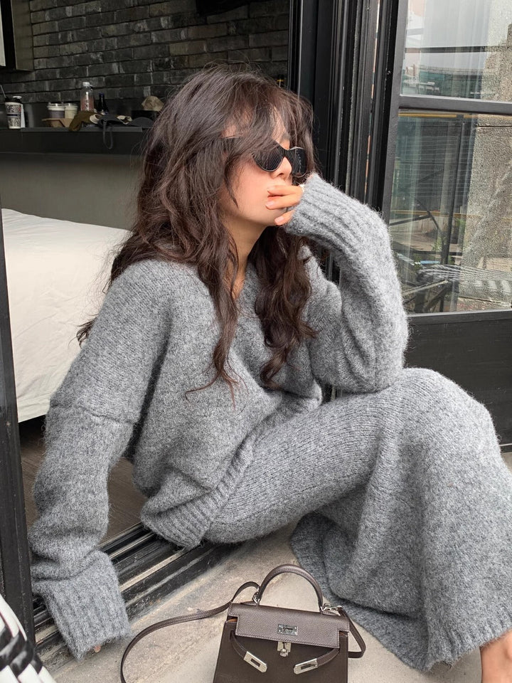 Women's elegant knitwear set: V-neck long sleeve sweater & midi skirt. Fashionable two-piece outfit for casual chic.