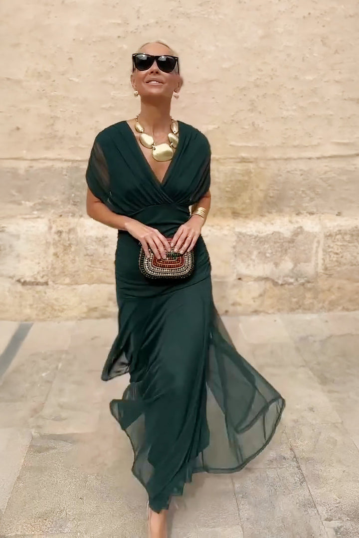 Flowy V-neck maxi dress for women, featuring soft fabric & delicate flutter sleeves. Ideal for spring fashion.