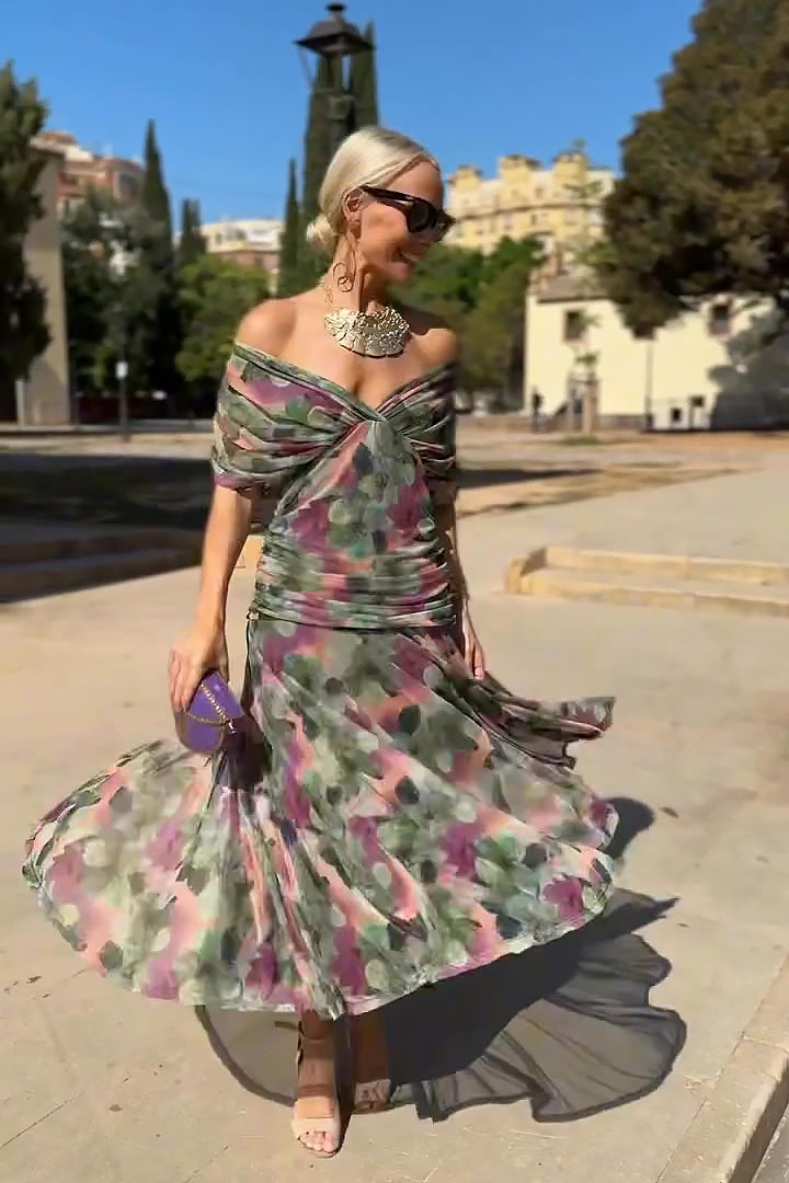 Women's V-neck maxi dress showcasing delicate flutter sleeves & a flowing silhouette. Very elegant.