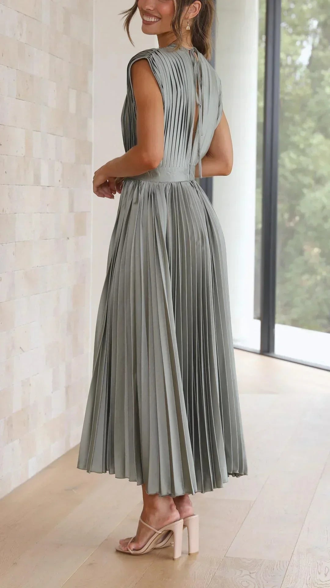 Casual yet elegant women's V-neck summer dress with a stylish adjustable tie back design. Midi length.