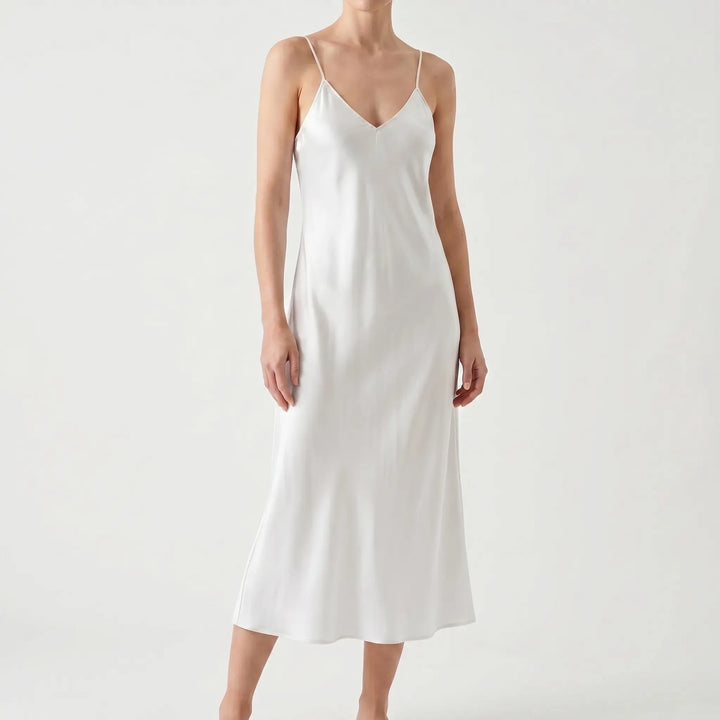 Stylish women's V-neck slip midi dress, ideal for summer evenings. Elegant solid color, comfortable spaghetti straps.