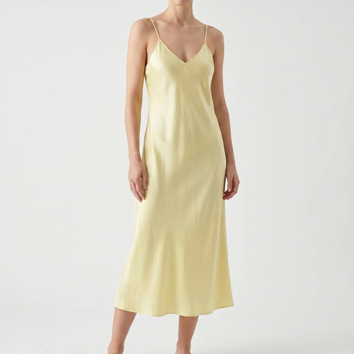 Women's elegant V-neck slip dress with spaghetti straps. Chic solid color midi for versatile fashion.