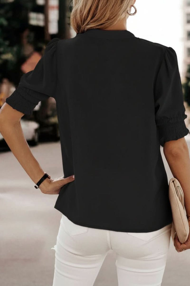 Chic women's V-neck top with short puff sleeves, perfect for an elegant and versatile look.