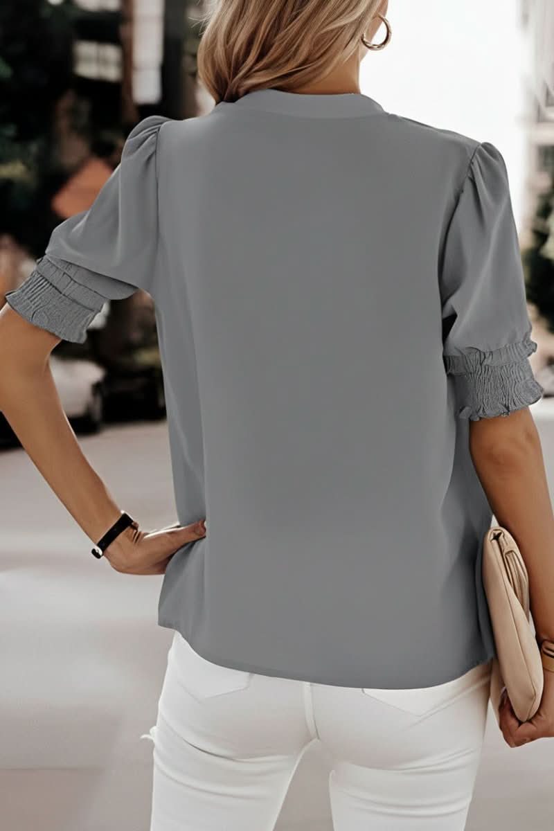 Model showcasing a women's elegant V-neck puff sleeve blouse, a versatile chic short sleeve top.