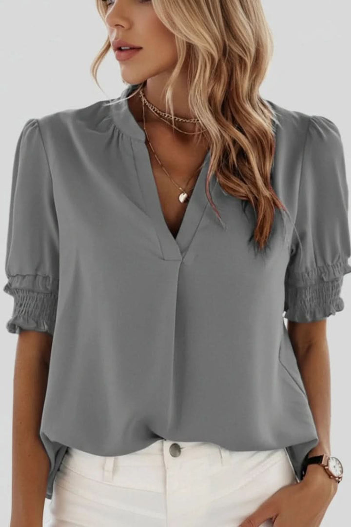 A modern women's V-neck puff sleeve top, combining elegant design with comfortable, casual style.