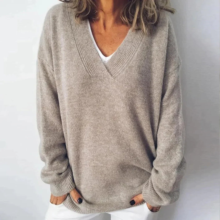 Elegant women's V-neck pullover sweater. Comfortable knitwear, perfect for fall and winter chic casual style.