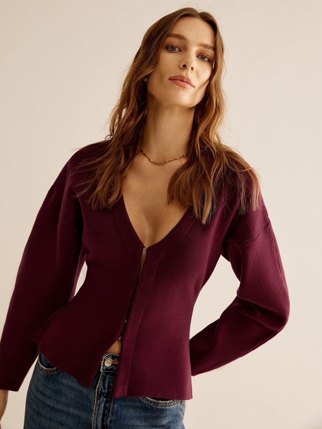 Celeste women's elegant V-neck sweater, slim fit. Professional long sleeve top for versatile styling.