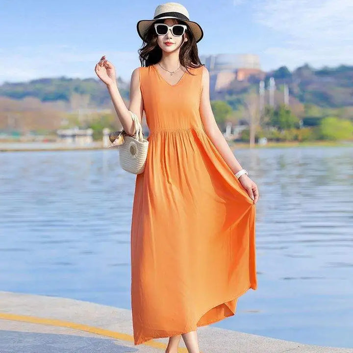 Back view of a flowy sleeveless maxi dress, showcasing the elegant tie waist & comfortable design.