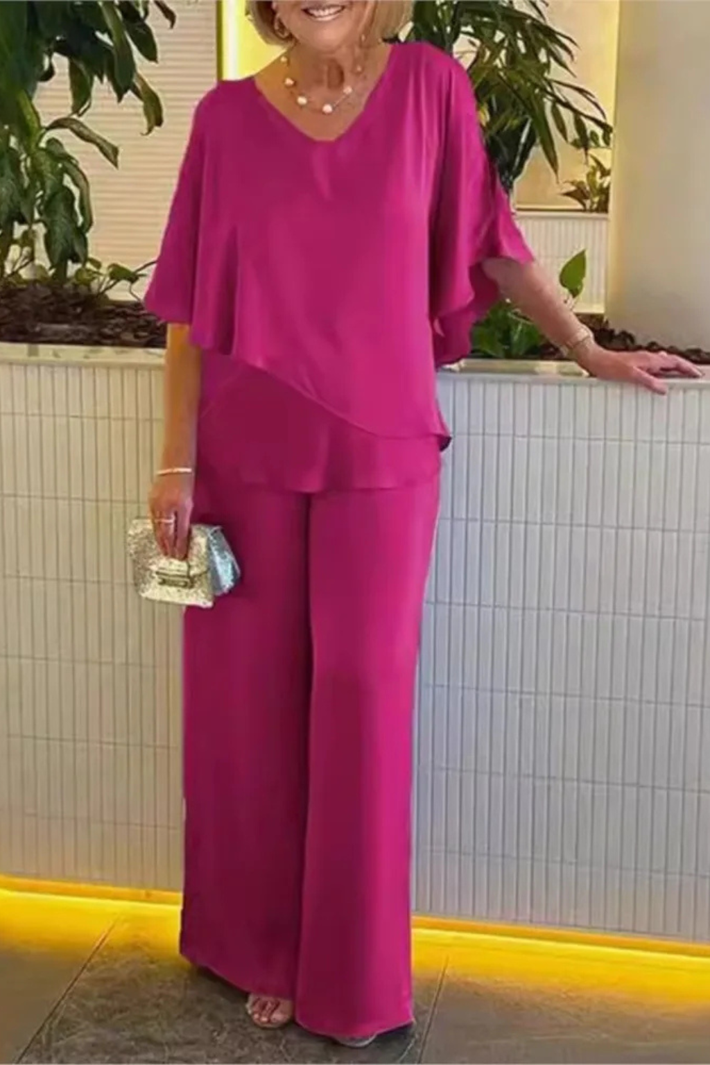 Sophisticated pink women's elegant V-neck batwing top & wide leg pants two-piece set.