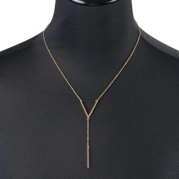 Elegant women's V-shape gold tone necklace. Minimalist stainless steel jewelry for timeless fashion.