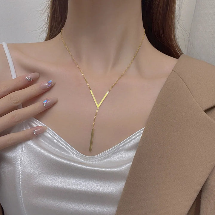 Timeless elegant V-shape gold necklace for women. Perfect minimalist fashion accessory for any outfit.