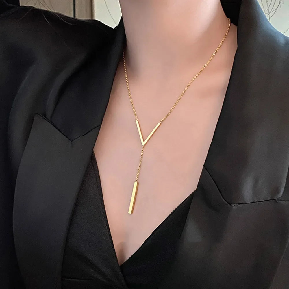 Close-up of a women's elegant V-shape gold tone necklace, showcasing its minimalist stainless steel design.