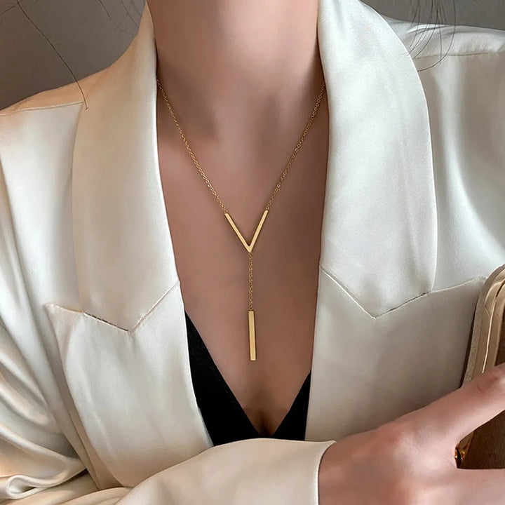 Women's elegant V-shape gold tone necklace. A sleek stainless steel fashion accessory with a minimalist design.