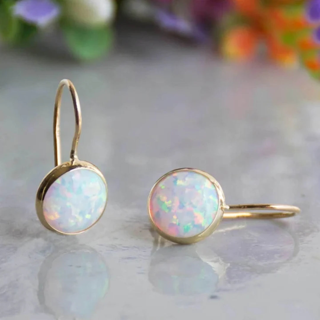 Elegant women's vintage gold-plated earrings with dazzling white opal gemstones. Classic women's jewelry accessory.