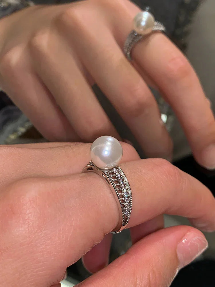 Elegant women's vintage openwork sterling silver ring with a classic pearl, perfect jewelry accessory.