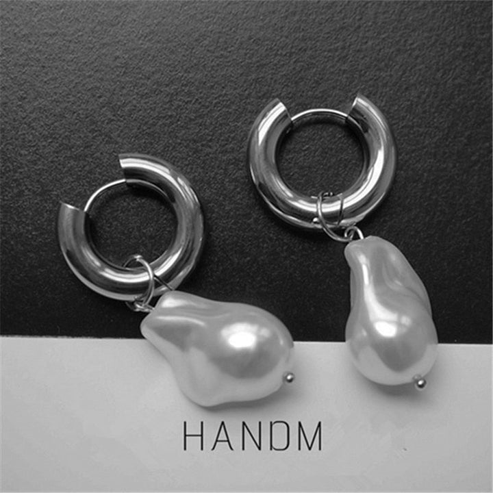 Stunning gold vintage pearl drop earrings for women, adding retro chic elegance to any outfit.
