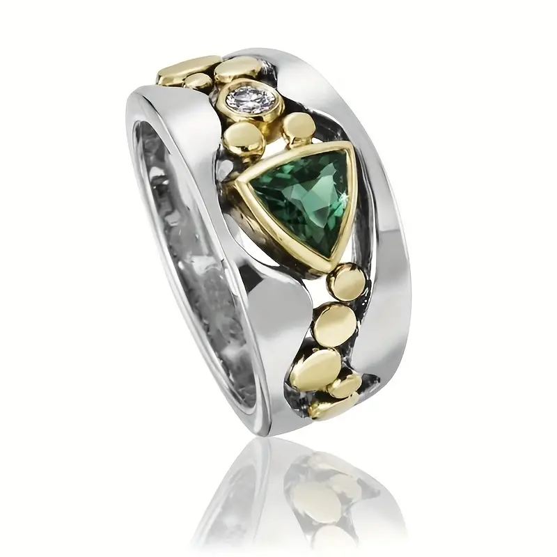 Elegant women's vintage ring with a vibrant green crystal gemstone set in a classic gold-tone setting. Fashion accessory.
