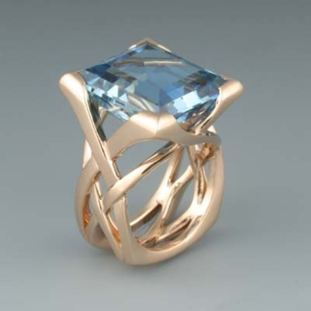 Elegant women's vintage rose gold ring featuring a stunning blue zirconia gemstone. Perfect statement jewelry accessory.