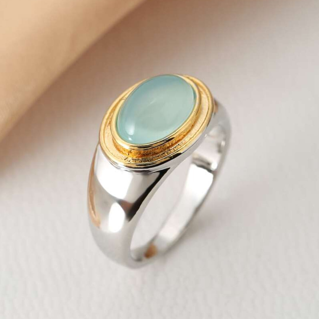 Elegant women's vintage silver ring with a striking green crystal stone and subtle gold accent. Perfect statement jewelry.
