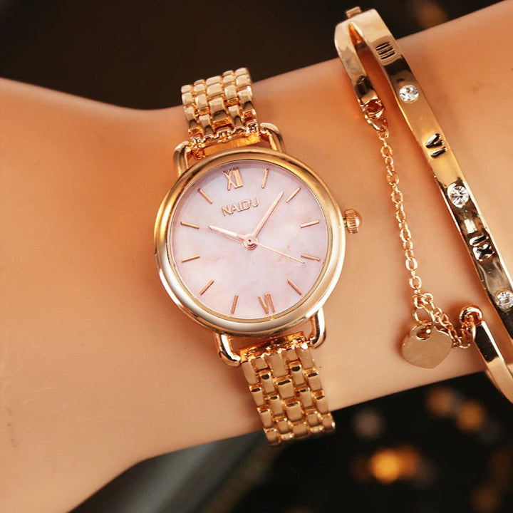 Silver women's watch, sophisticated marble dial & durable stainless steel band. Fashionable accessory.
