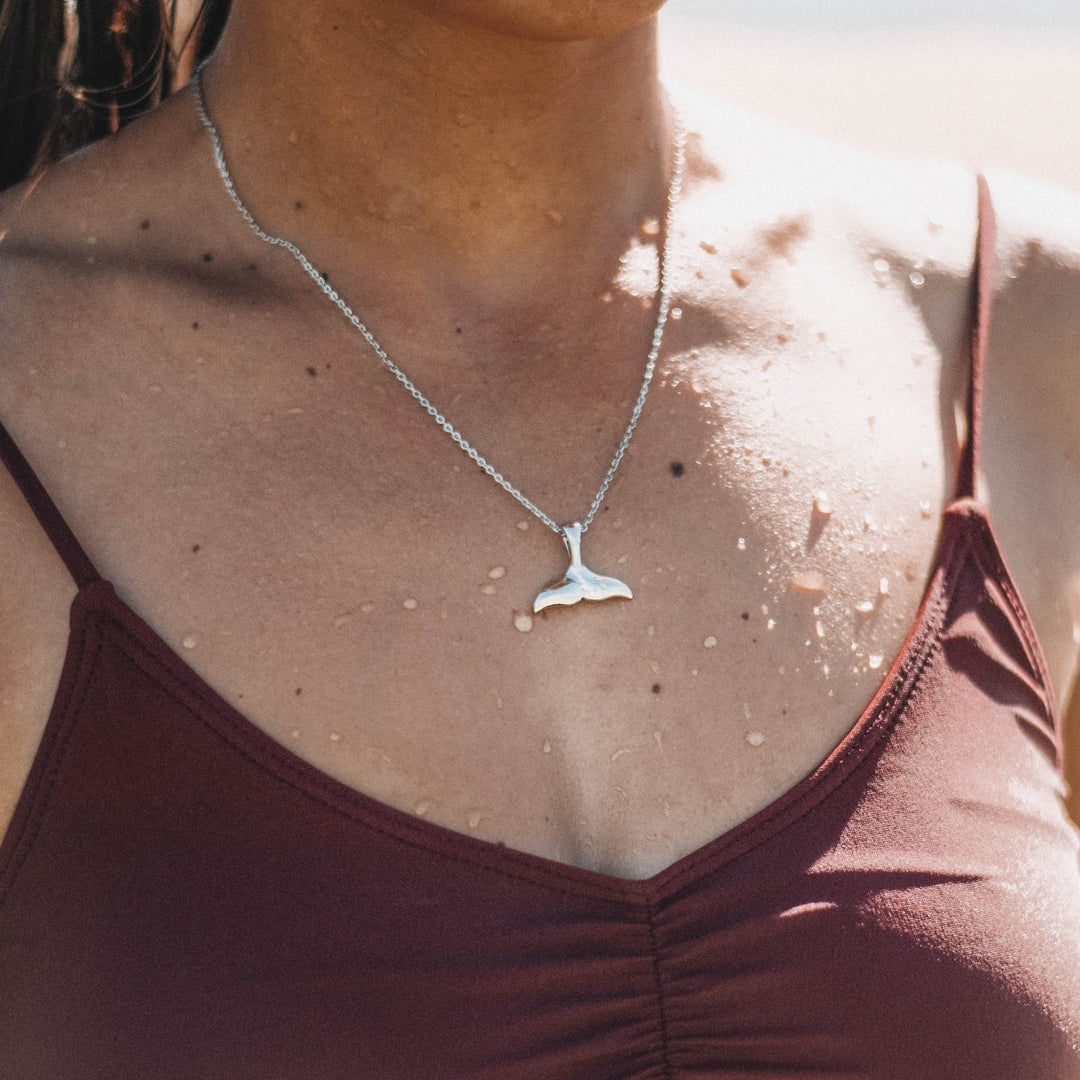 Golden whale tail pendant necklace, a stunning piece of women's ocean jewelry. Perfect for sea lovers.