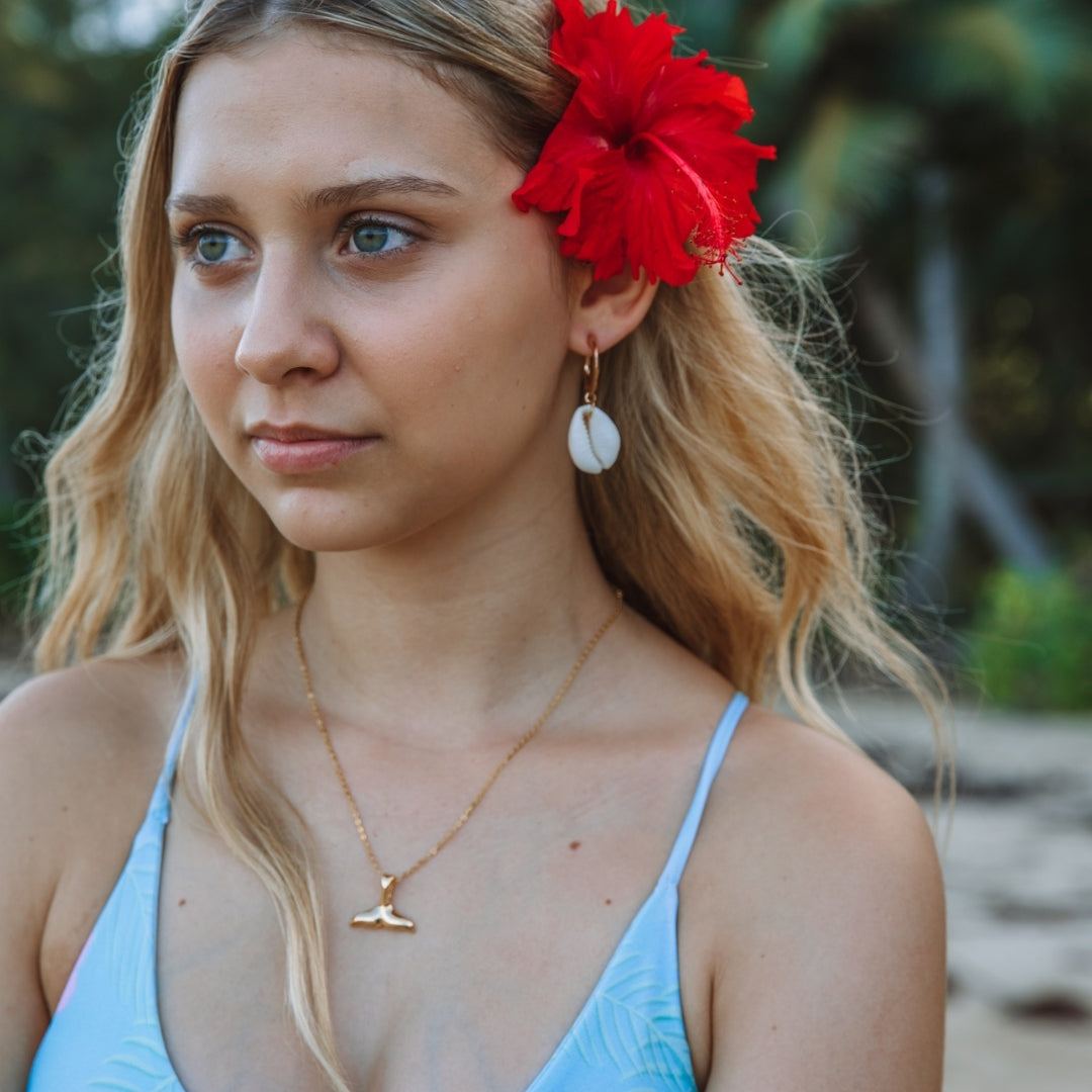 Symbolic whale tail pendant necklace, elegant women's ocean jewelry representing freedom and strength.