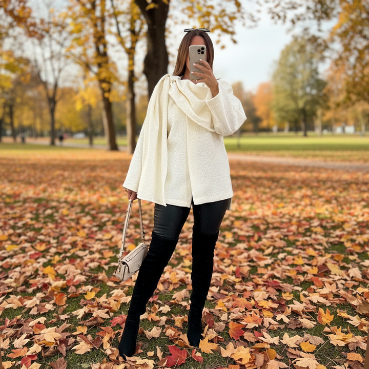 Elegant women's white boucle poncho with integrated scarf detail, perfect winter fashion