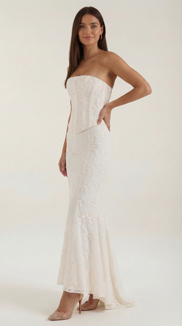 Stunning white strapless corset maxi dress, an elegant formal gown with a mermaid silhouette and delicate fabric for special occasions.