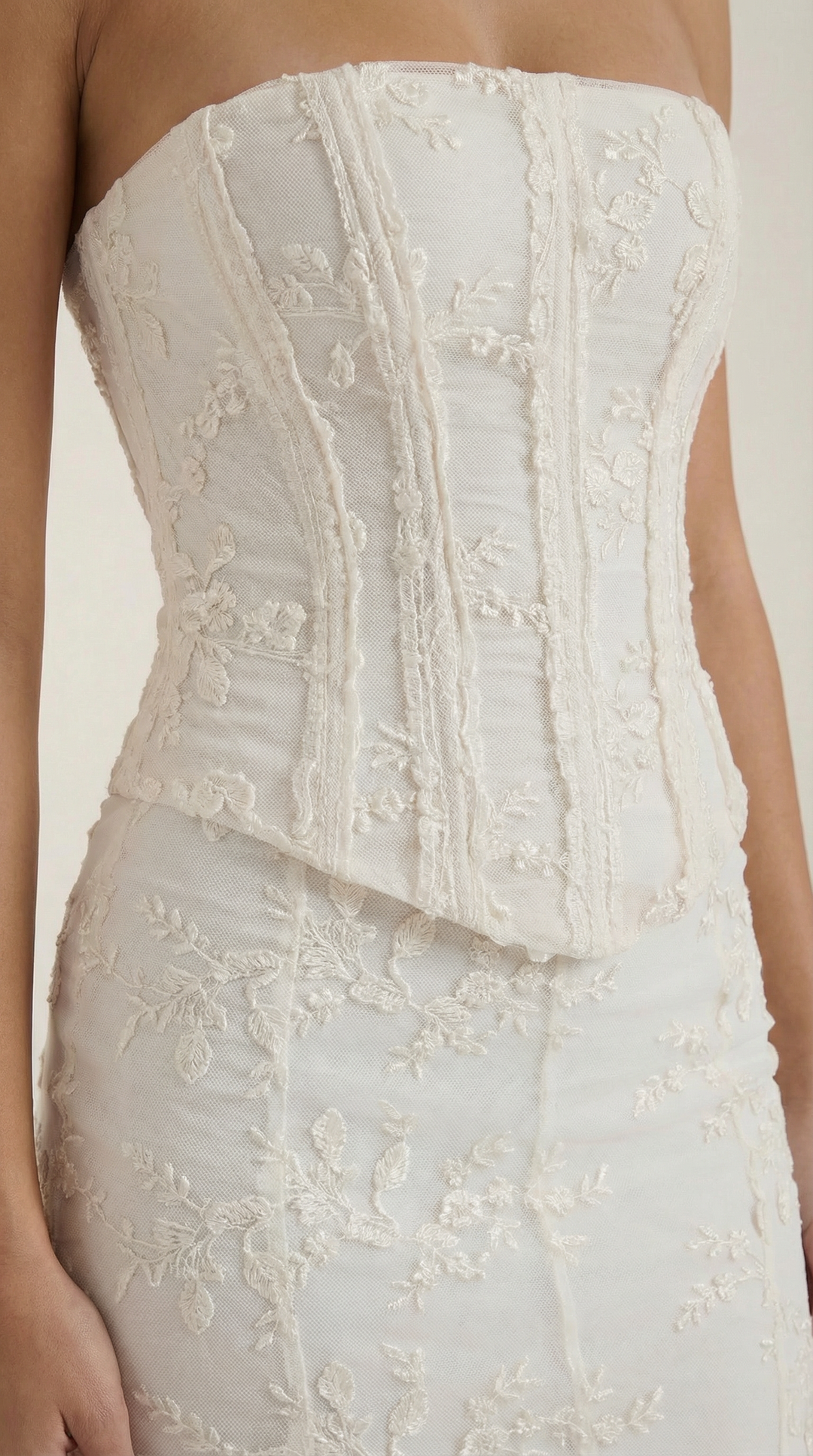 Beautiful women's strapless white maxi dress featuring a structured corset top and flowing mermaid skirt for elegant evening wear.