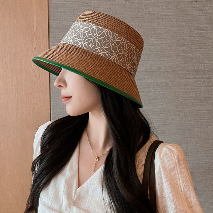 Elegant women's wide brim sun hat with a decorative bow, perfect for summer fashion and sun protection.