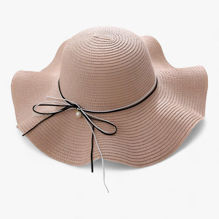 Stylish women's wide brim hat with a prominent bow, designed for ultimate sun protection during summer