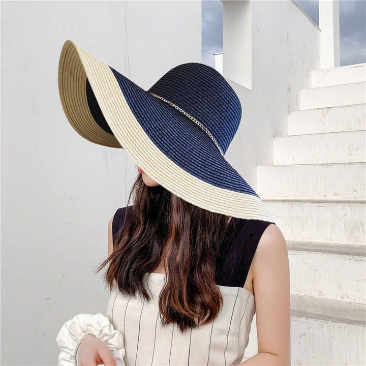 Elegant women's wide brim UV protection summer hat, 'Lily' in straw, perfect for beach fashion.