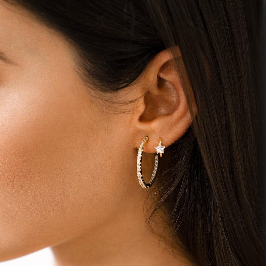 Trendy gold wide hoop earrings for women, adorned with brilliant star zirconia, adding a touch of sparkle.