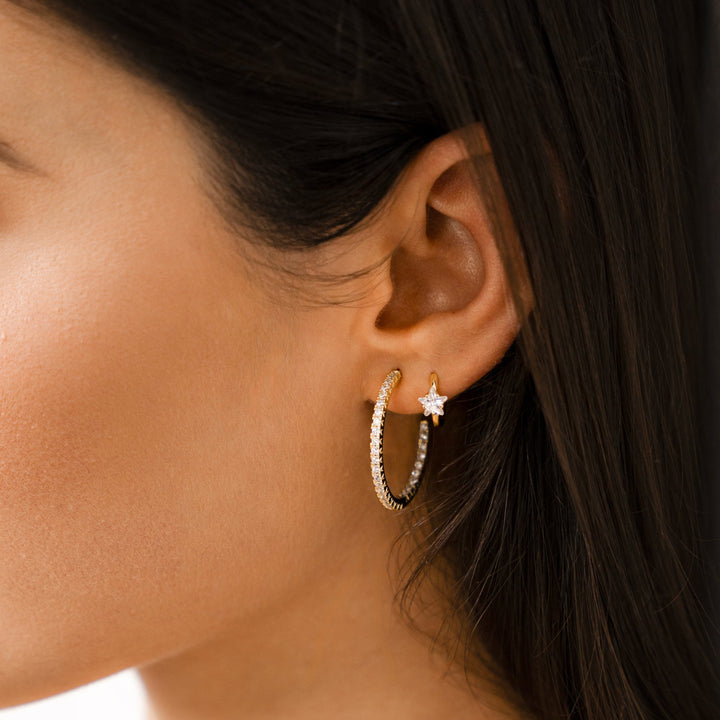 Trendy gold wide hoop earrings for women, adorned with brilliant star zirconia, adding a touch of sparkle.