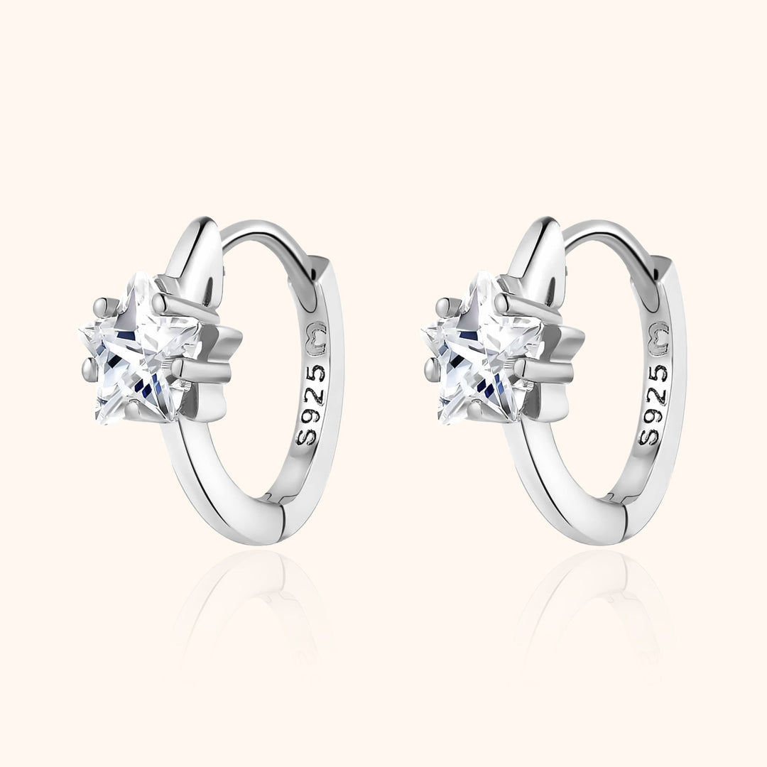 Women's sparkling wide hoop earrings, available in silver or gold, with elegant star zirconia embellishments.