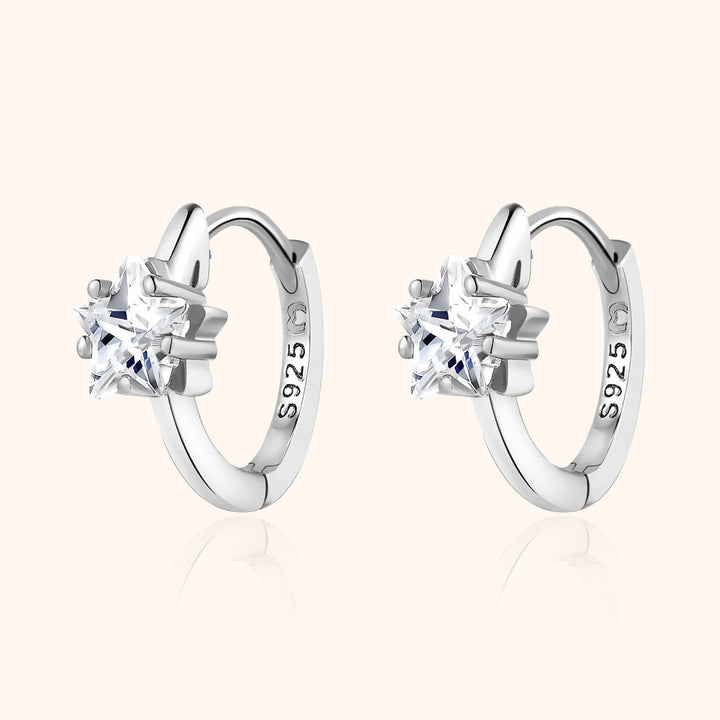 Women's sparkling wide hoop earrings, available in silver or gold, with elegant star zirconia embellishments.