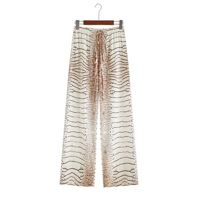 Elegant women's wide leg chiffon summer trousers in white, perfect for beachwear or casual outings. Liana design.