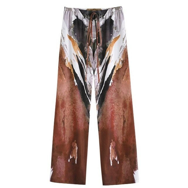 Fashionable women's Liana wide leg chiffon trousers with an elasticated waist, suitable for versatile summer styling.