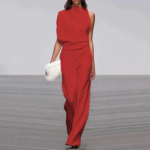Woman confidently wearing a flattering solid color wide-leg jumpsuit, ideal for a chic summer or resort look.