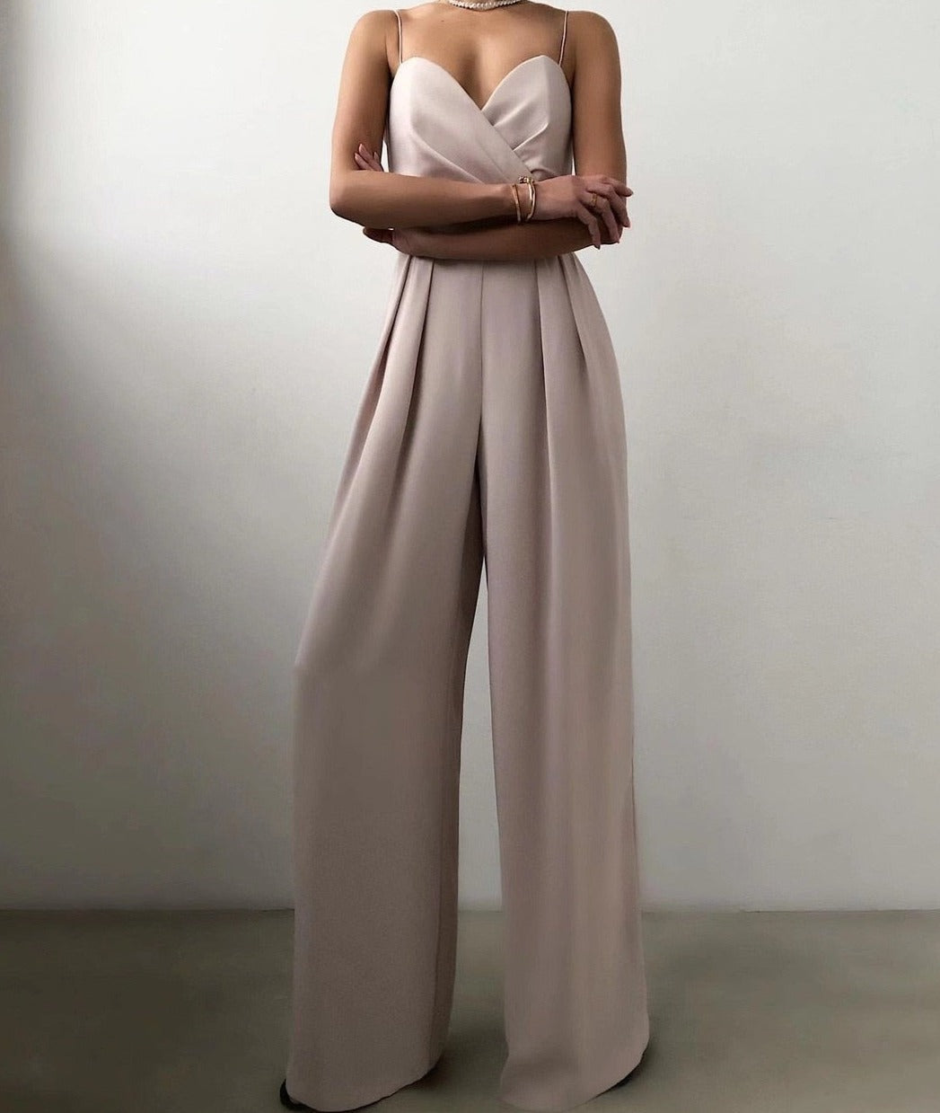 Soft pink elegant wide-leg jumpsuit for women, featuring thin spaghetti straps, a chic choice for formal wear.