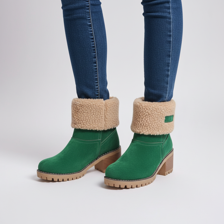 Women's black winter boots, faux fur lined and weatherproof, showcasing elegant design and comfort