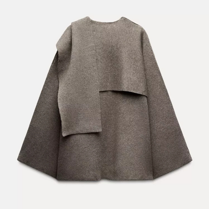 Fashionable women's winter poncho, chic fall style layering piece.