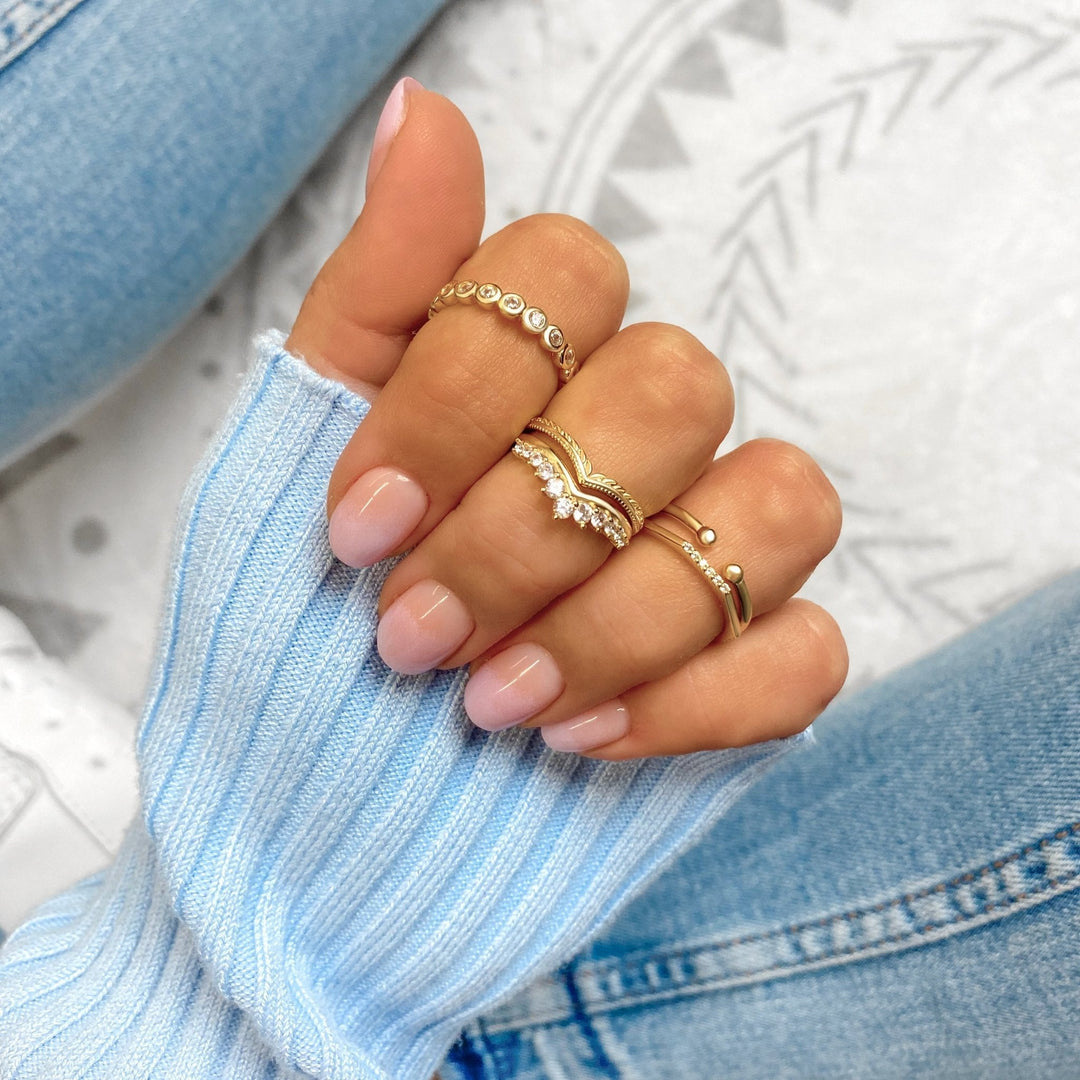 Sparkling gold plated sterling silver crown ring for women, featuring brilliant zirconia stones. Elegant jewelry.