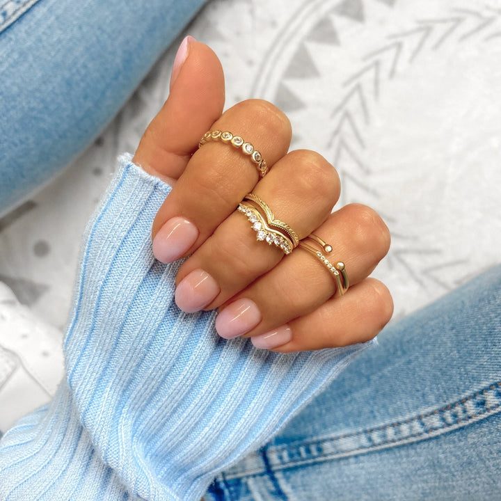 Sparkling gold plated sterling silver crown ring for women, featuring brilliant zirconia stones. Elegant jewelry.