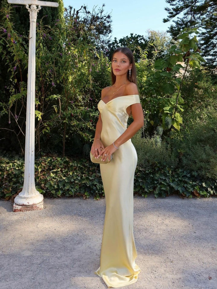 Elegant yellow off-shoulder maxi wedding guest dress with sweetheart neckline. Perfect formal evening gown for women.