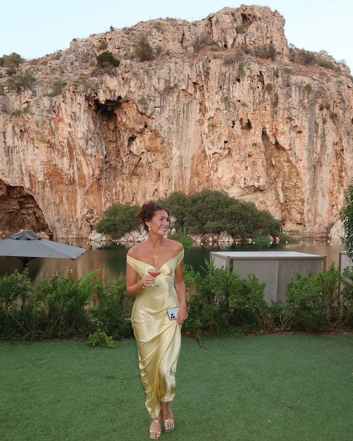 Fashionable women's yellow off-shoulder maxi dress. Elegant wedding guest formal dress with sweetheart neckline.
