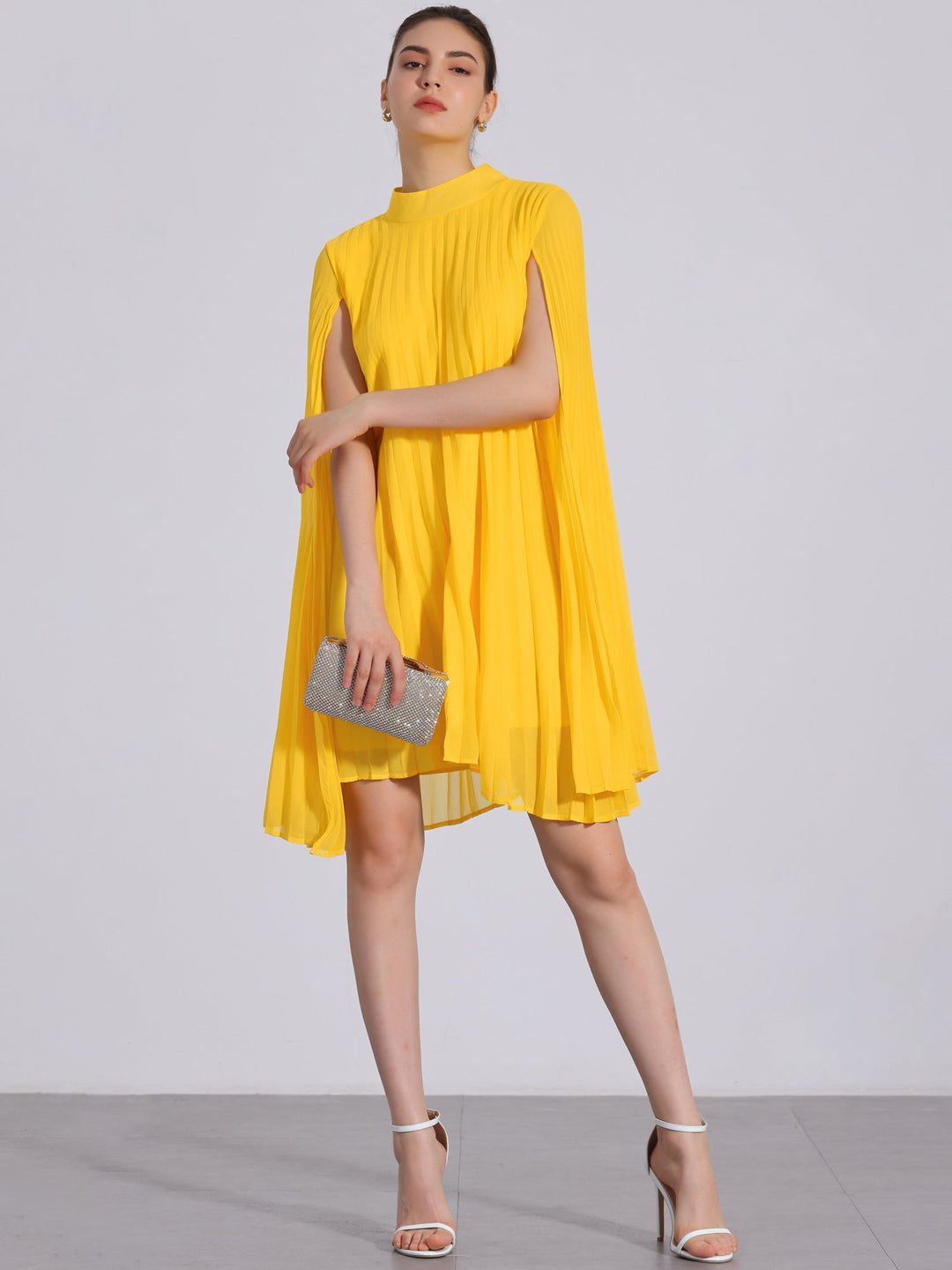 Elegant yellow pleated swing dress with mock neck & cape sleeves for women's party or evening wear.